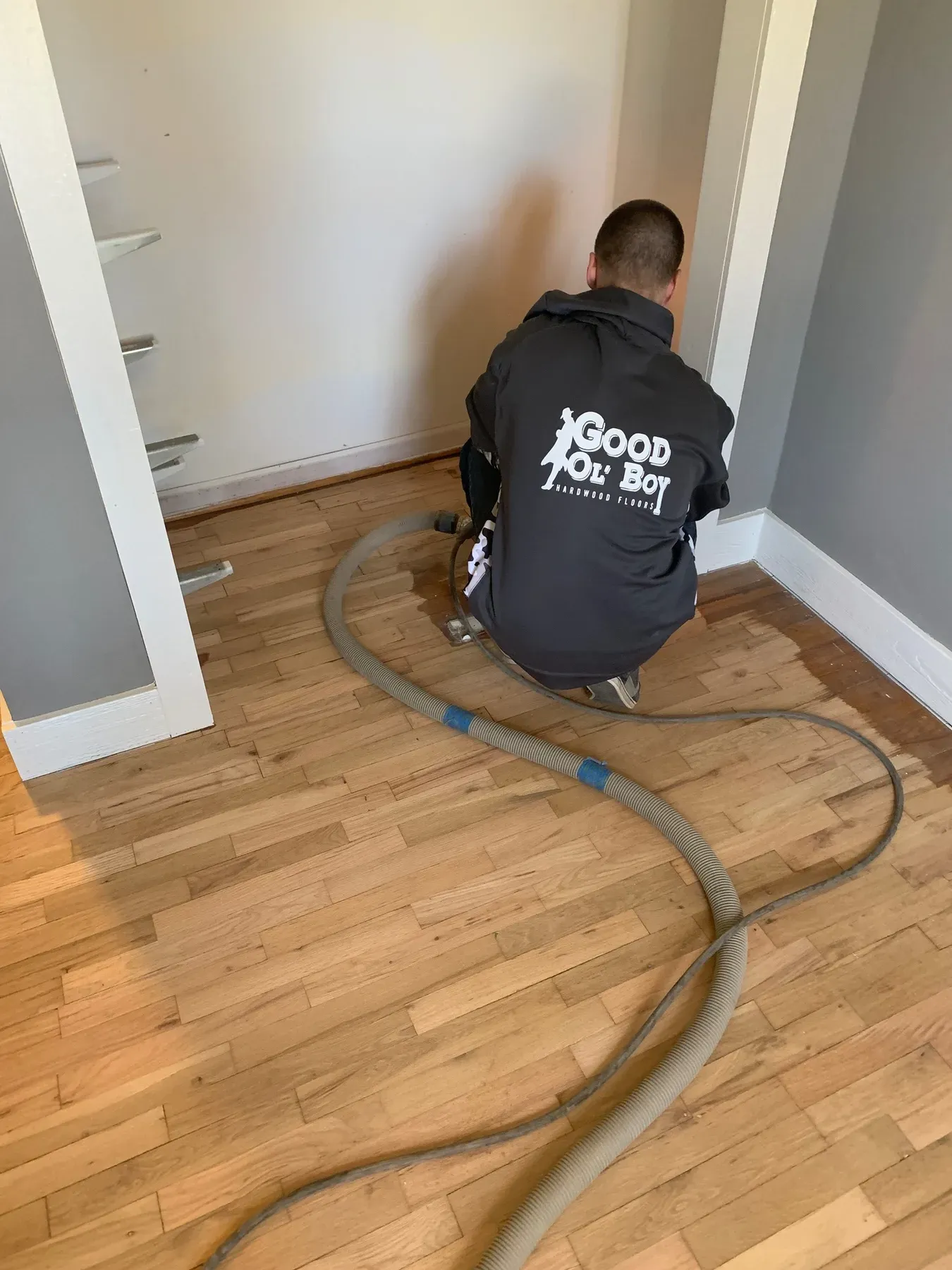 The Good Ol' Boy crew refinishing a hardwood floor in a Kansas City home